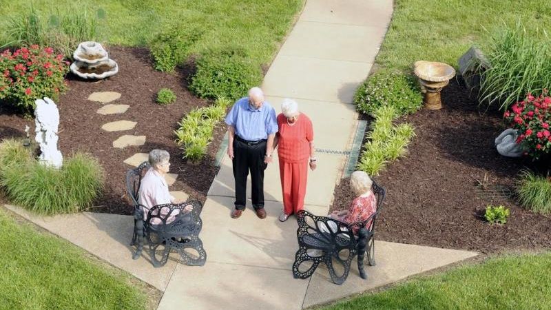 Seniors enjoying the greenery at Lake St. Charles Retirement Community