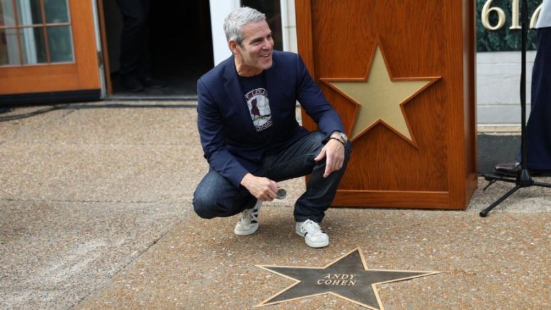 Andy Cohen posing by his star on the St. Louis Walk of Fame